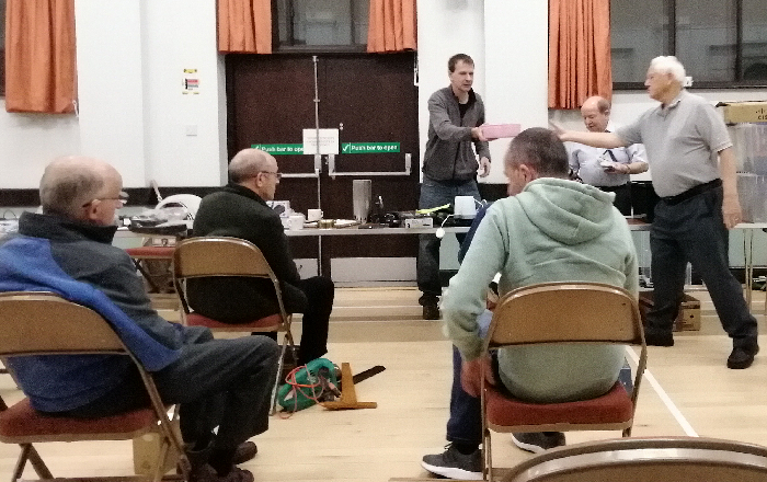 Chris M1CSE as auctioneer, Mike G8KMP as runner and Dave M0LDP as cashier